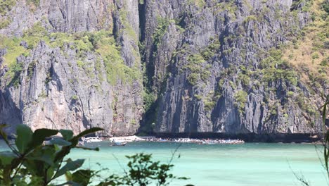 boat navigating through turquoise waters near cliffs