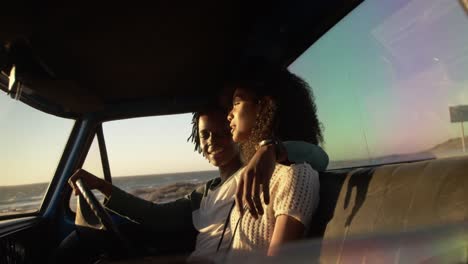 couple sitting together in pickup truck a beach 4k