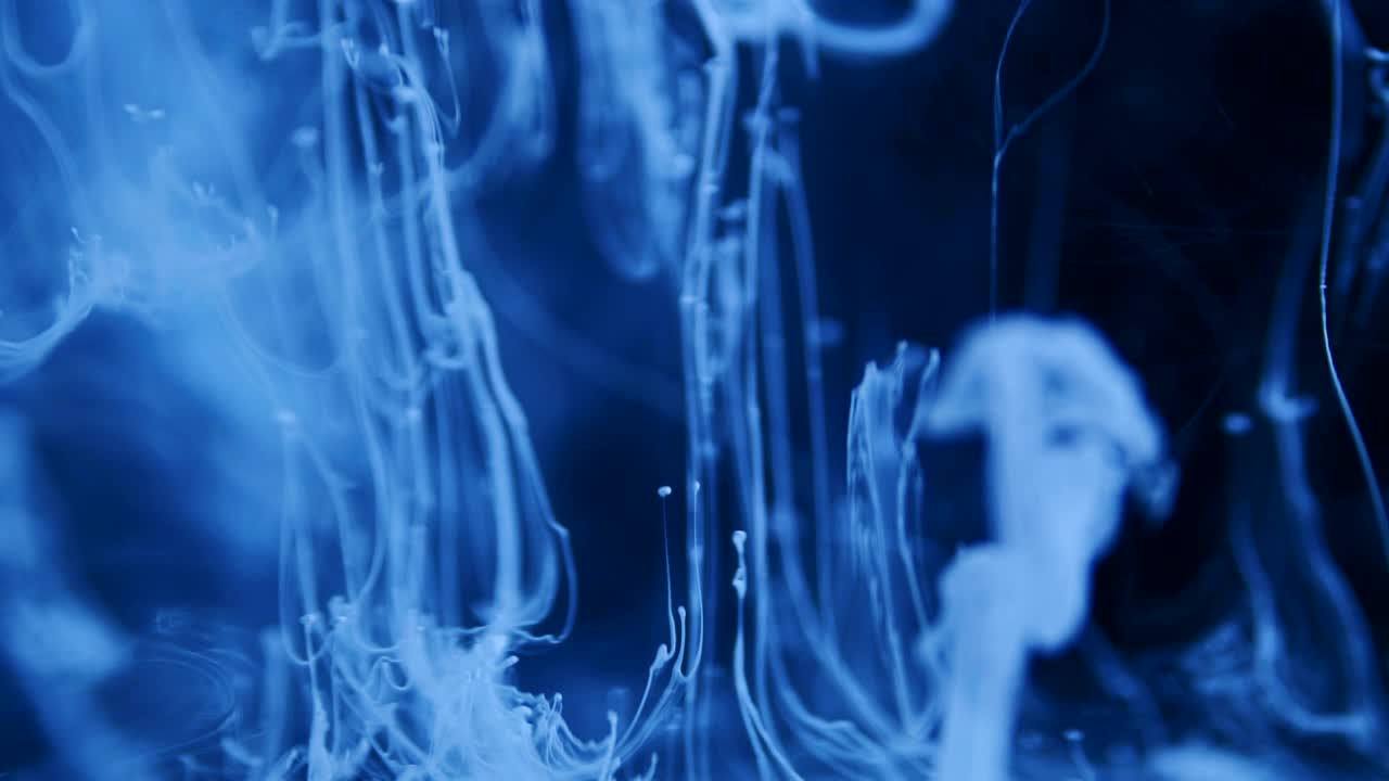Shot of Ink Moves. Cosmic abstraction of a light blue particle ink. macro