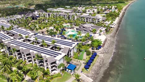 aerial view of luxury resort hotel with pool, palm trees at denarau island beachside