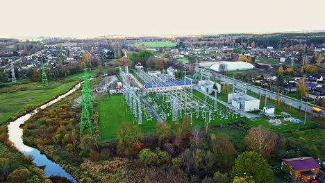 Panoramic-drone-shot-circling-a-electric-power-station,-cloudy,-spring-day