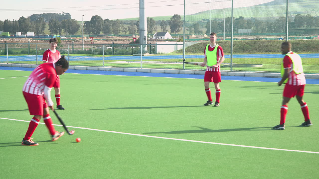 Playing field hockey, male players in action during practice session outdoors