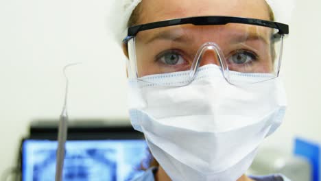 dental assistant holding dental tool