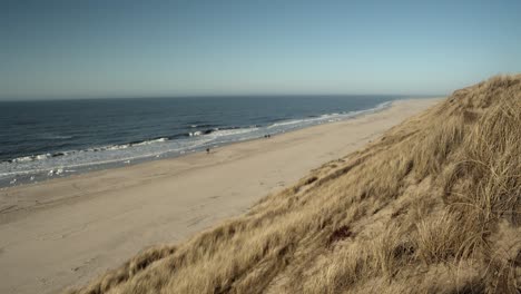 beach of sylt on a sunny day with people walking by