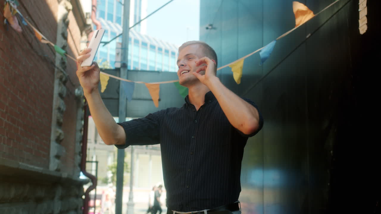 Man taking a selfie in a city street