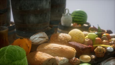 food table with wine barrels and some fruits, vegetables and bread