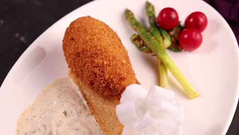 gourmet fried chicken with asparagus and sauce