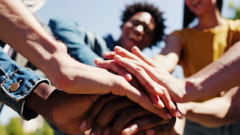 diverse hands stacked together symbolizing teamwork and unity