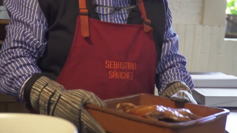 Slowmotion-tracking-shot-of-a-freshly-cooked-pig-being-placed-down-on-a-wooden-board