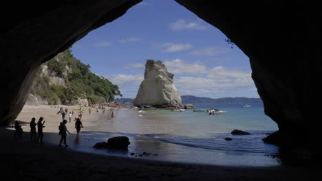 super wide shot of te hoho rock and cathedral cove beach with natural cave arch