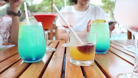 people enjoying vibrant cocktails outdoors