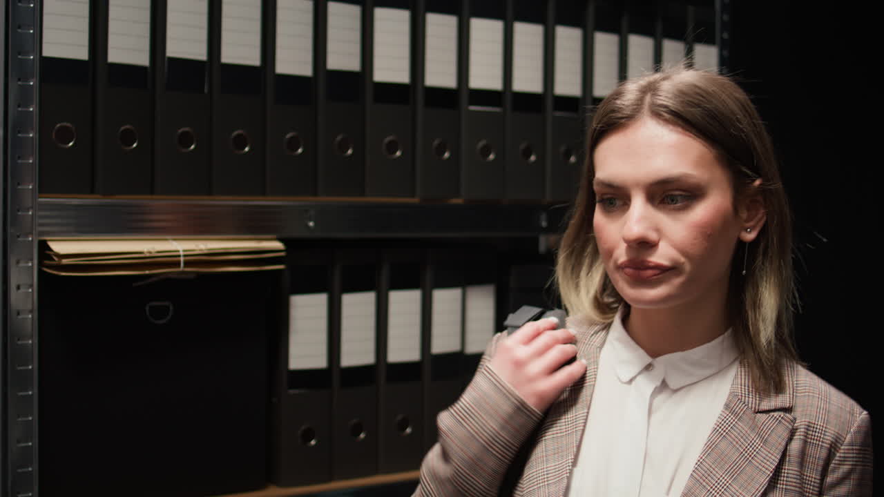 Woman packing up in office surrounded by files