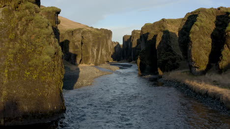 low aerial shot through fjaðrárgljúfur canyon iceland