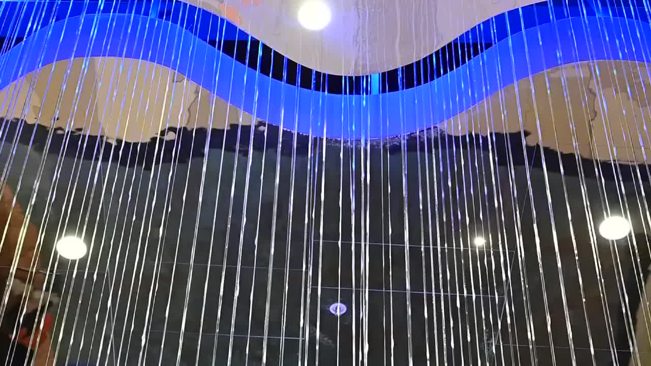 Close up view of a light curtain and blue wave ceiling in Nicosia Mall, Cyprus, emphasizing lines, reflections and modern architecture