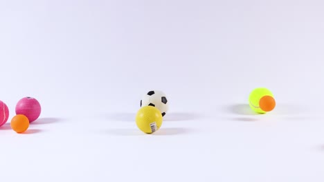 various balls bouncing in a white space