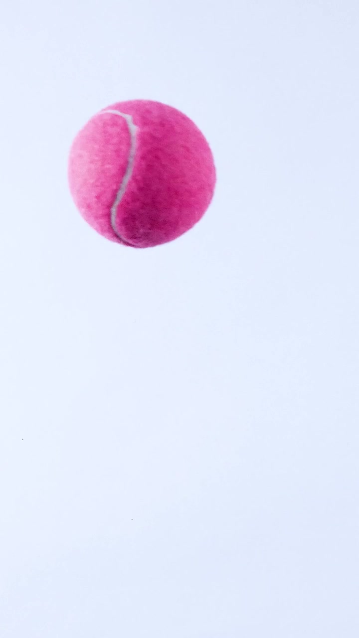 A tennis ball bounces across a surface