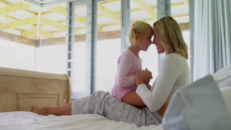 mother and daughter having fun in the bedroom 4k