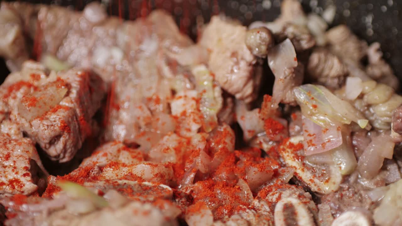 Chicken or pork stew with red and green pepper onion, and spices cooking in a frying pan. Traditional mexican cuisine, tacos preparation, ragout.