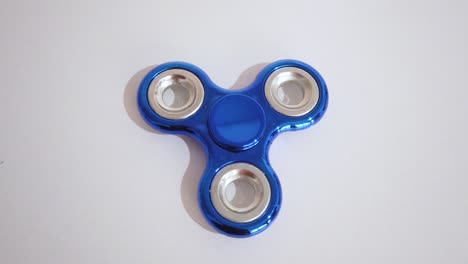 toy to relax known with spinner in blue color with white background.