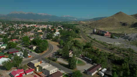 aerial cinematic drone mid summer downtown salida s lime mill colorado near buena vista on arkansas river riverside park scout surfing wave biking hiking rafting rocky mountain forward movement