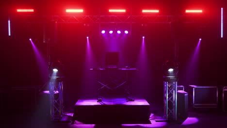dj setup stage with red and purple lighting