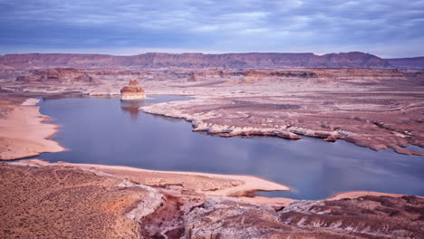 Drone captures a sweeping motion over a striking landscape, with Lake Powell and Glen Canyon beyond.