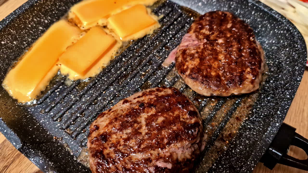 Closeup of sizzling grilled meat and cheese ready for serving with a side of fresh vegetables