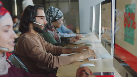 Middle-Eastern-Man-in-Headset-Working-in-Call-Center