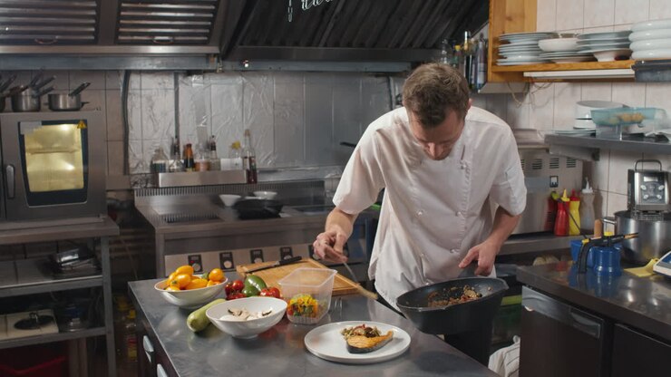Chef Serving Asian-Style Vegetables On Plate