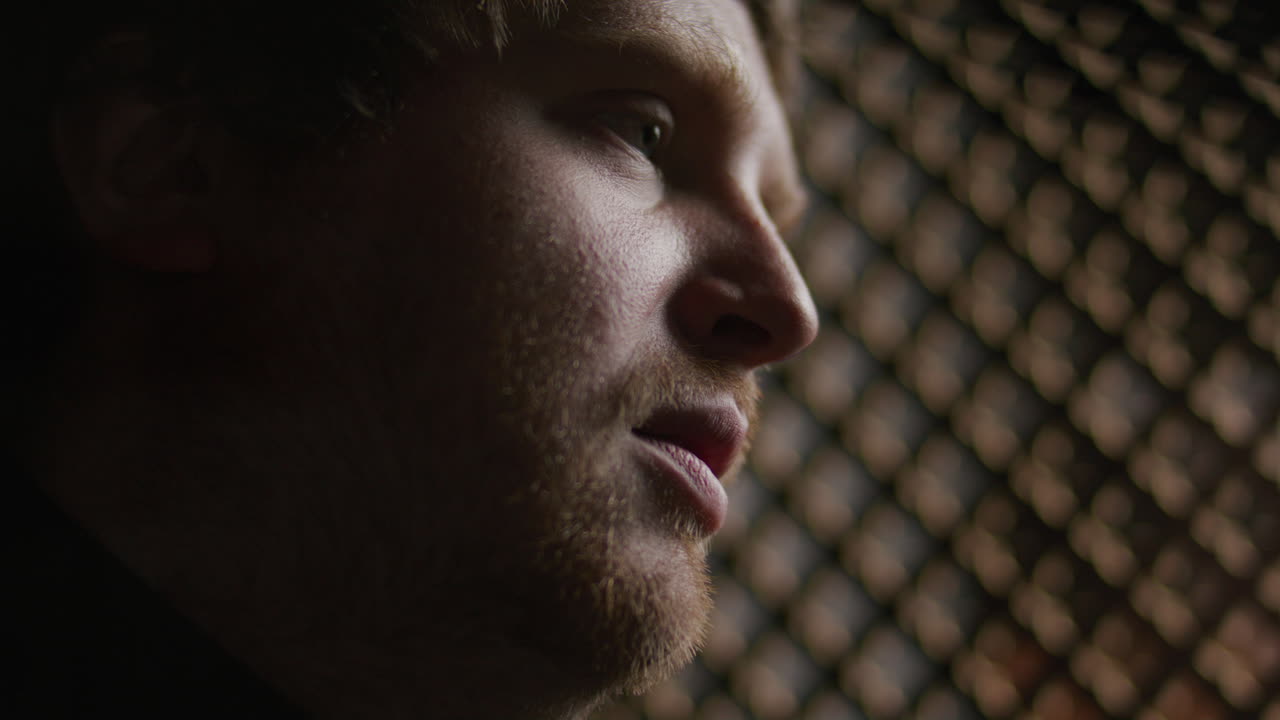 Close Up of Priest Speaking Softly inside Confessional Booth