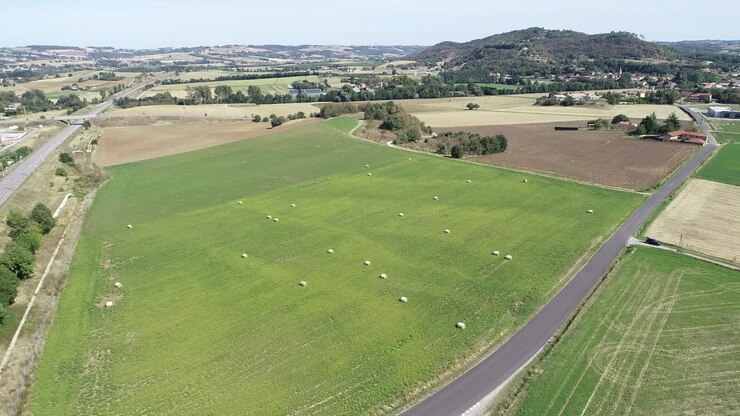 Drone shot of french farmland with hay bales
