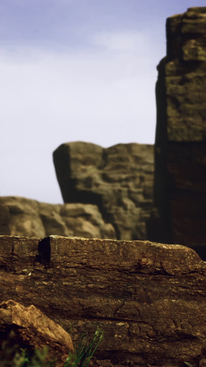 Rocky canyon landscape with dramatic cliffs and clear sky at sunset