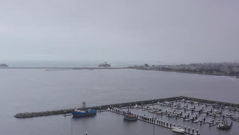 low aerial dolly shot of crescent harbor in crescent city, california during a storm. 4k