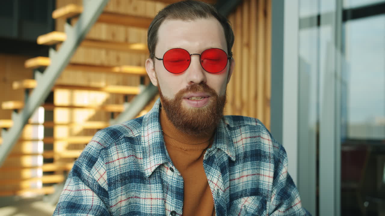 Man wearing red sunglasses