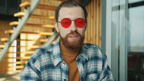 man wearing red sunglasses