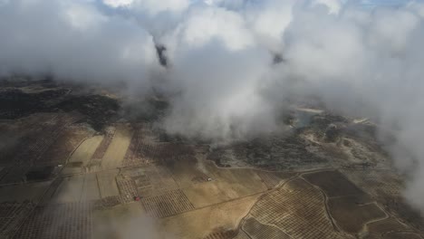 overhead farmland in the gray cloudy sky