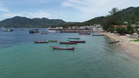 tropical beach with boats and clear blue water