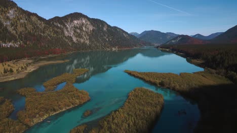 el pintoresco speicher de sylvenstein en otoño, el lago del embalse del río del valle de la montaña con agua azul fresca en los alpes de baviera austria, fluyendo por un hermoso bosque a lo largo de los árboles cerca de walchensee