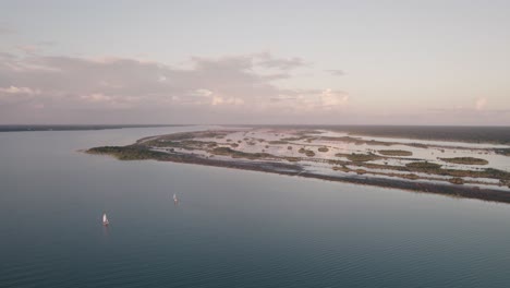 White-Sailboats-Cruising-Through-The-Sea-Near-The-Coast-Of-Mexico---aerial-shot