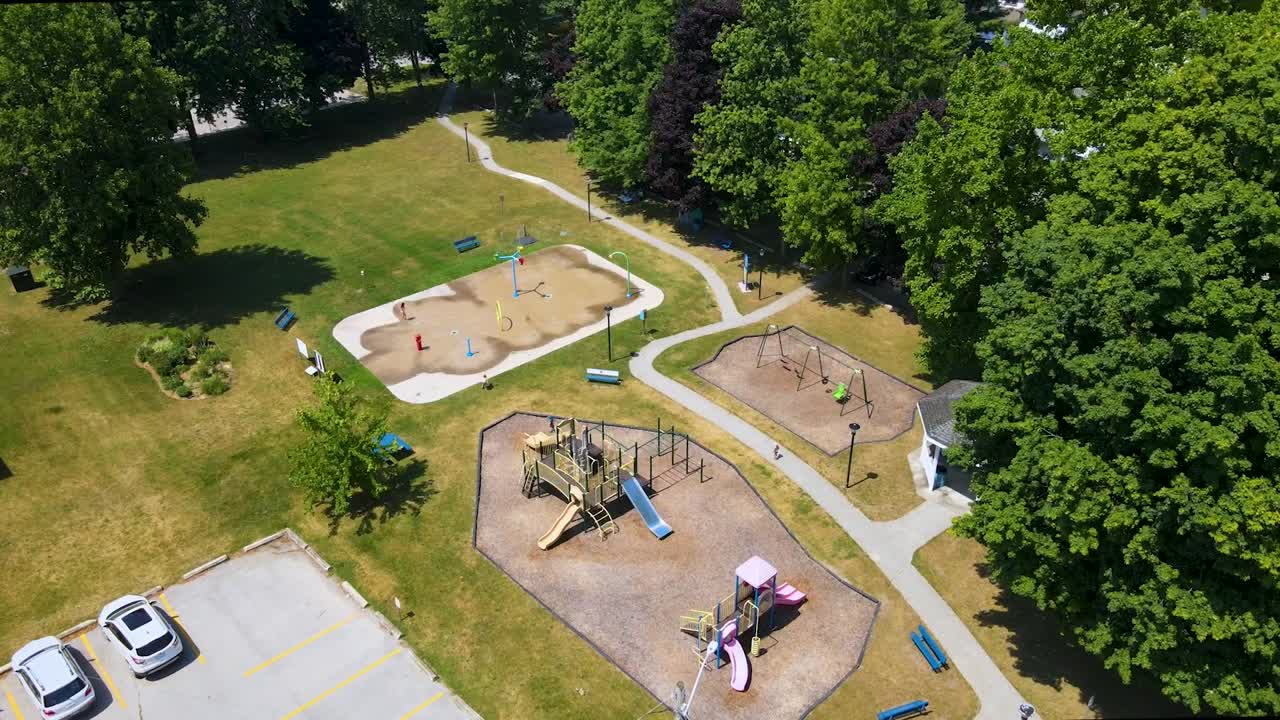 Flying over a park on a sunny summer day in a small town near London, Ontario