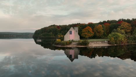 clear water with mirrored reflections of old stone church in west boylston, massachusetts, usa