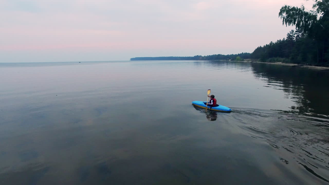 Free stock video - Drone view of young athlete paddling on canoe in sea