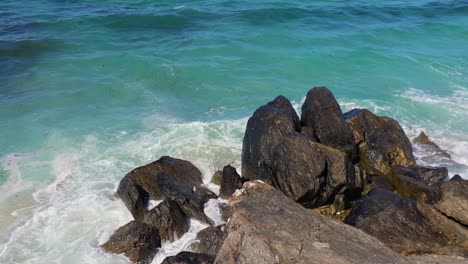 sea waves crashing on the rocky shore of malpica beach in spain