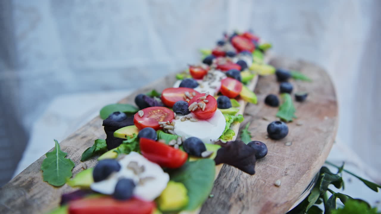 A delicious bread veggie platter for good, healthy meal of avocado and tomatoes baguette sandwich - close up