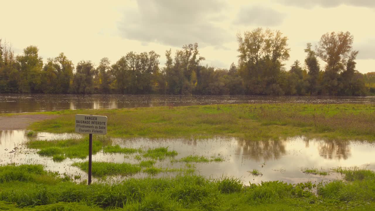 Serene view lush greenery with Maie river flowing during sunset in Angers, France.