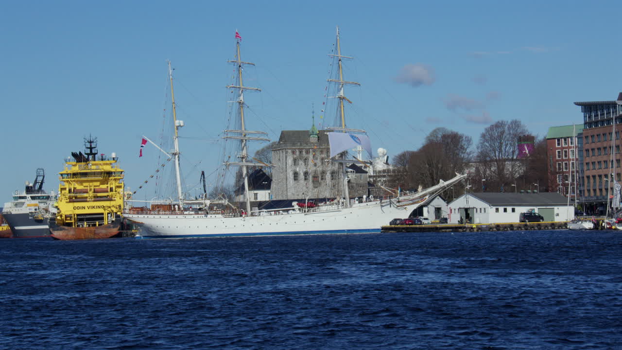 Wide shot of a tall ship moored up in the Harbour Vagen bay at Bergen