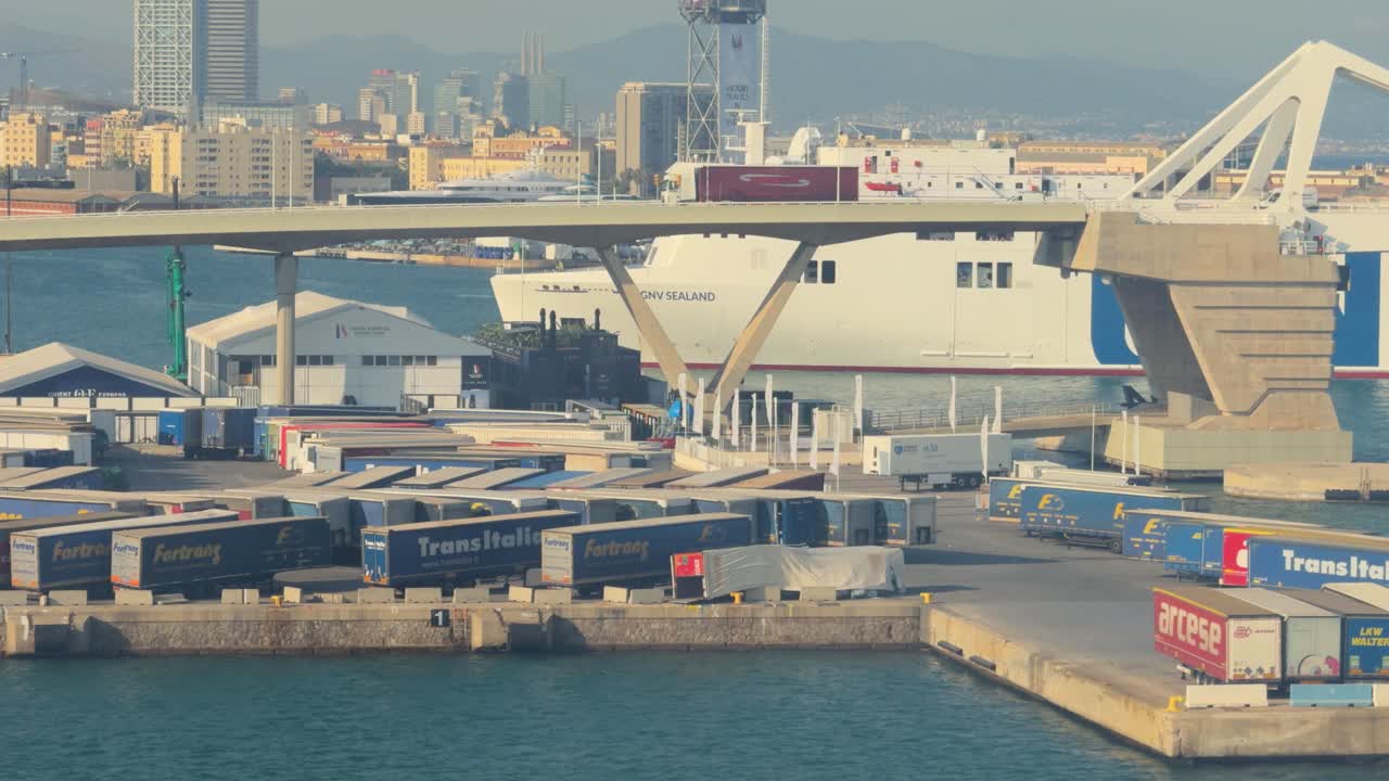 Port of Barcelona, close-up of ferry ship, approaching with bridge and hotels in the background