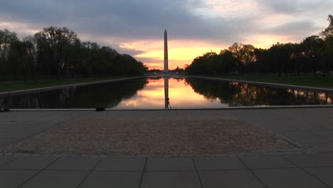 the washington monument is centered in this shot that includes the reflecting pool