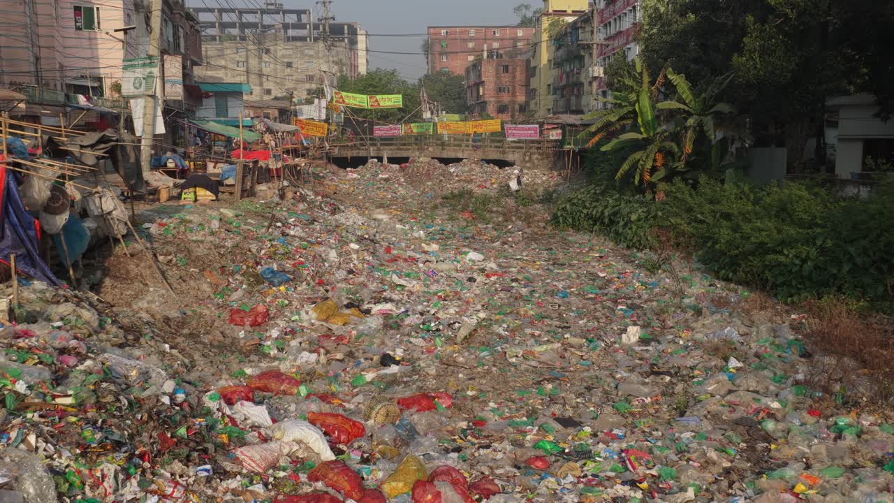 Urban Riverbed Completely Filled with Plastic Waste and Garbage
