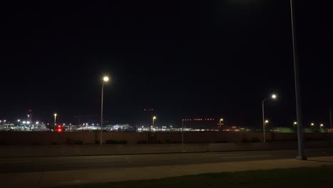 airplane landing at airport runway at night